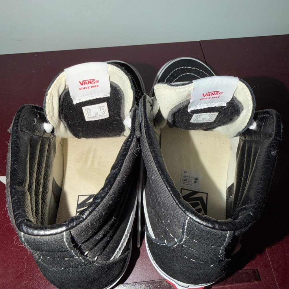 Vans Women's Black and White High-Top Sneakers